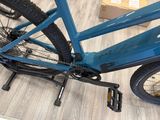 a blue bicycle that is sitting on the floor