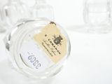 a glass jar with a label on it sitting on a table