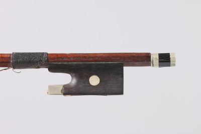 an image of a violin bow with a piece of wood sticking out of it