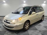 a picture of a beige minivan parked in a room