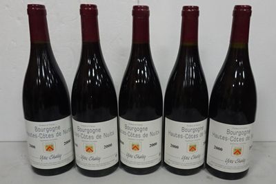 six bottles of wine are lined up on a table