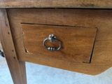 a wooden table with a drawer with a ring on it