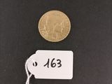 a close up of a coin with a tag on it