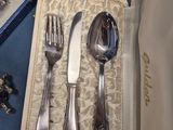 a box with silverware in it on a blue table