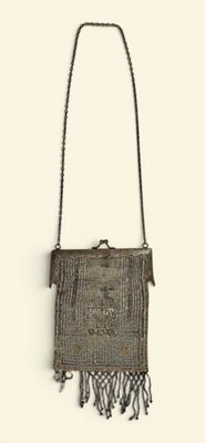 an image of a woven purse hanging on a wall