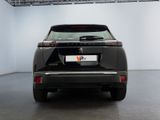 the rear end of a black car in a white room