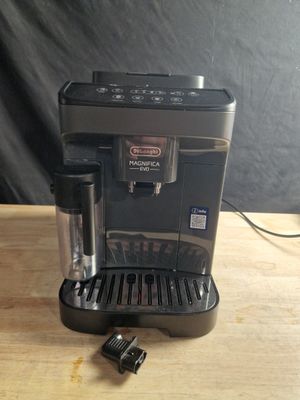 a close up of a coffee maker on a wooden table