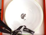 a white bowl in a box with a black ribbon