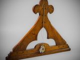 an image of a wooden clock with a bell hanging from it ' s side