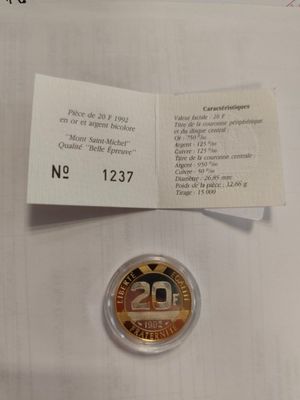 a close up of a coin on a white surface with a price tag