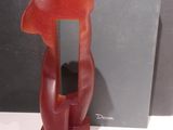 a red sculpture of a dog on a stand