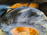 a close up of a tractor tire with a yellow wheel