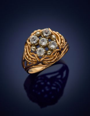 a gold ring with a cluster of diamonds set in the center