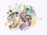 a pile of different colored stones on a white surface