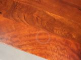 a close up of a wooden table with a knife on it