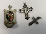 three religious items are displayed on a white surface