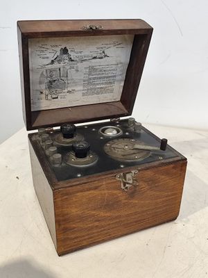 une vieille boîte en bois posée sur une table, contenant deux microscopes
