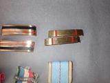 several different types of ties and bracelets laid out on a table