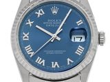 a close up of a wrist watch with roman numerals on it