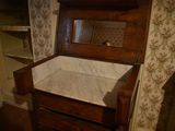 a wooden dresser with a mirror on top of it