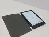a tablet computer sitting on a table with a cover