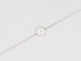 a close up of a silver bracelet on a white background