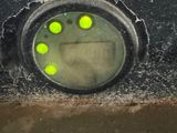 a close up of a clock on the side of a vehicle