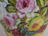 a vase with a floral design on it sitting on a table