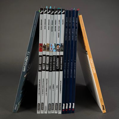 books stacked on top of each other on a gray surface
