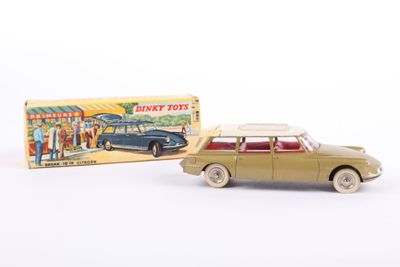 a toy car and a box of toys on a white surface