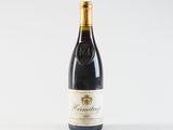 a bottle of wine sitting on top of a white table