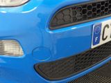 a close up of a blue car with a number plate on it