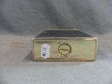 a metal box with a tag on it on a table