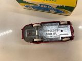 a toy car that is sitting on a table next to a box