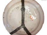a white plate with a black strap on it