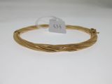 a gold plated bracelet with twisted wire and a price tag