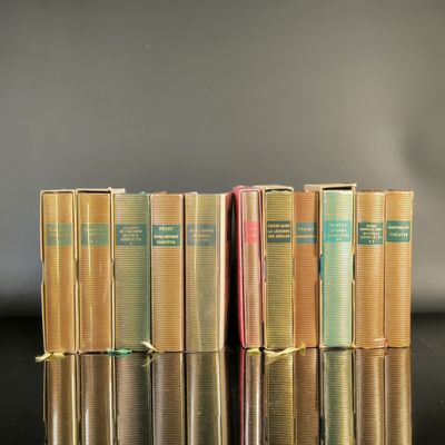 several books are stacked on top of each other on a table