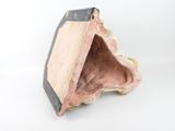 a small piece of pottery that is sitting on a white surface