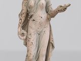 une vieille statue représentant une femme tenant un oiseau dans la main