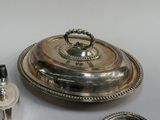 a silver plate with a lid on a table