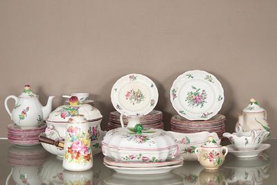 une table en verre sur laquelle sont disposés de nombreux services de table différents