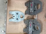 two clamps that are sitting in a box on the floor