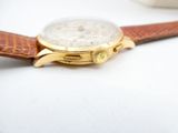 a close up of a watch on a white surface