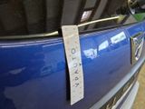 a sticker on the door of a car that has a price tag attached to it