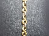 a close up of a gold chain bracelet on a mannequin mannequin mannequin mannequin mannequin mannequin mannequin mann