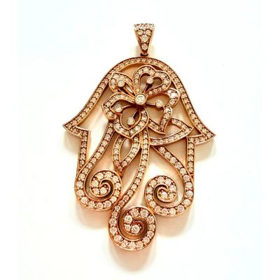 une image d'un pendentif en forme de main de Hamsa sertie d'un diamant, sur fond blanc