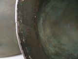 a close up view of a metal vase with rust on it