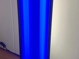 a blue glass lamp that is on a wooden table