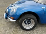 an image of a blue sports car parked on the side of the road