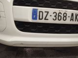 a close up of a white car with a number plate on it